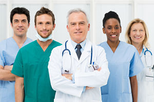 Four Medical Professionals smiling (two females and three males)