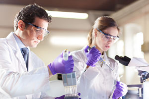 Two Lab workers (female and male) doing some testing